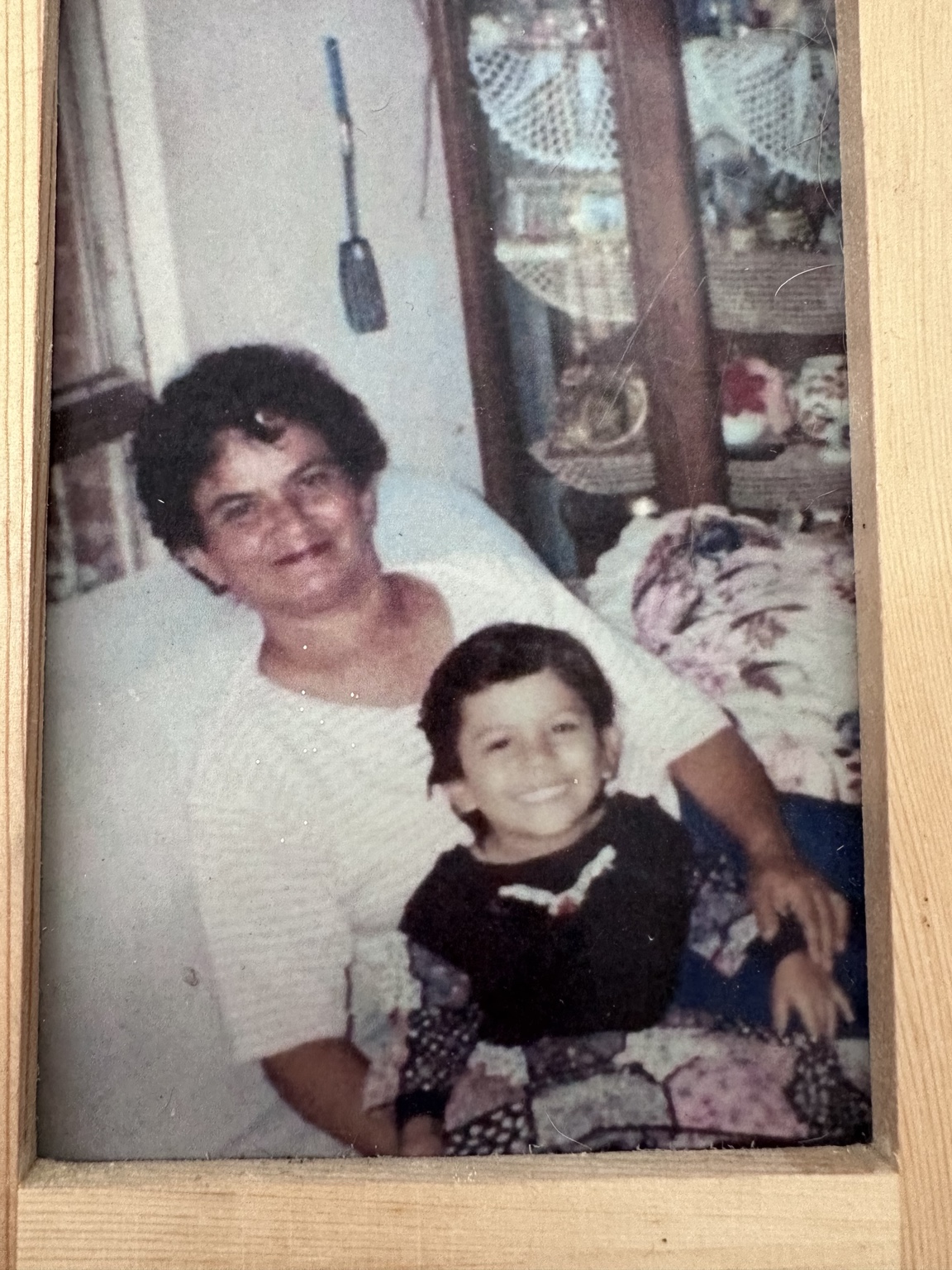 Family photograph of Itaa with a child, in its wooden frame