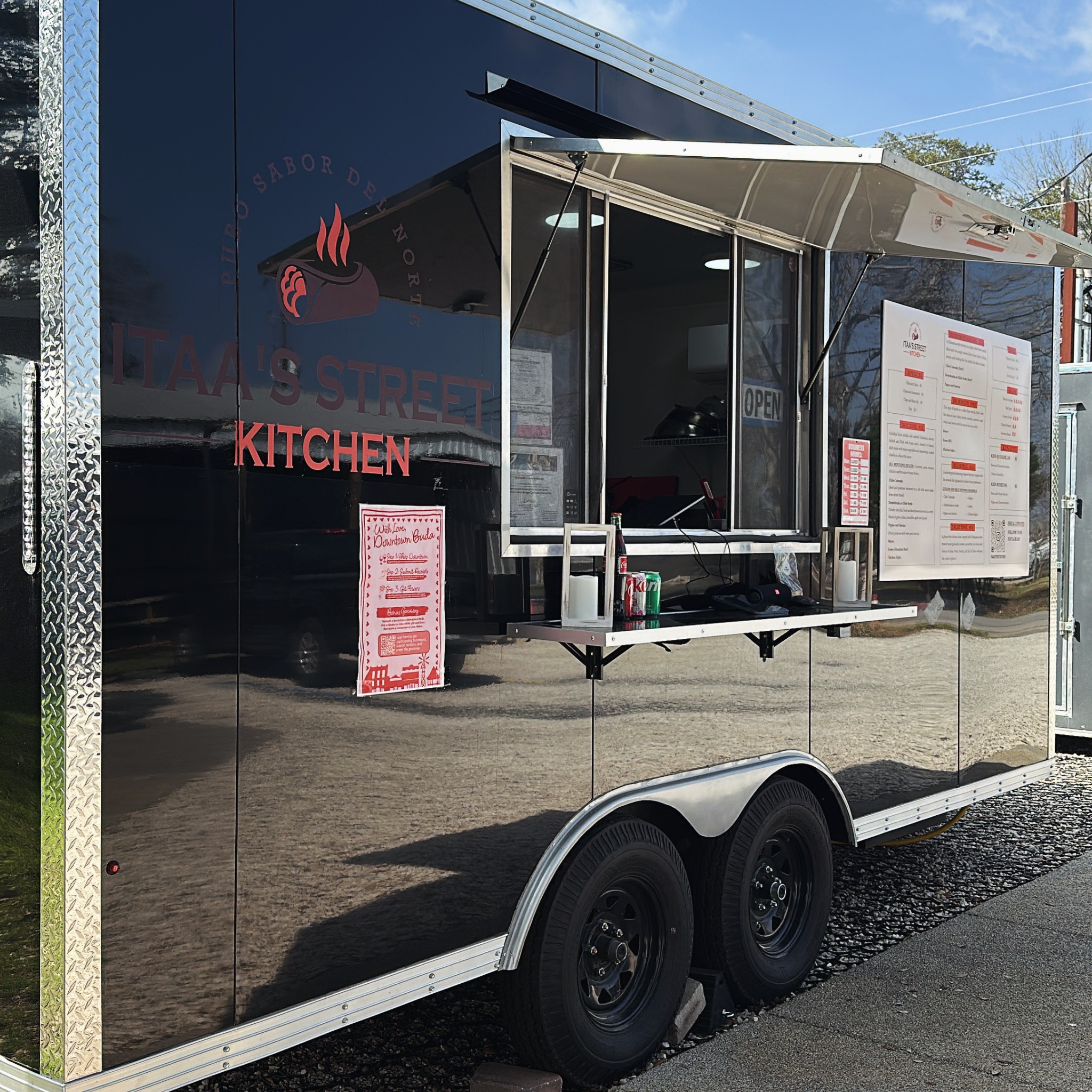 Itaa’s Street Kitchen food truck with its serving window open and menu displayed